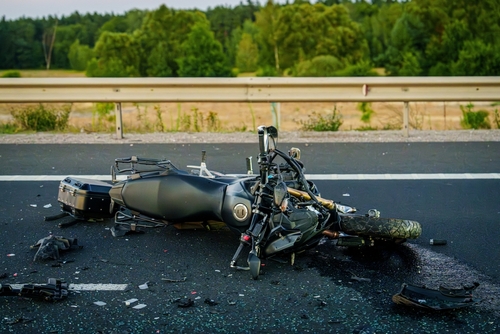A motorcycle broken down on the road to represent a case where a motorcycle accident lawyer would review.