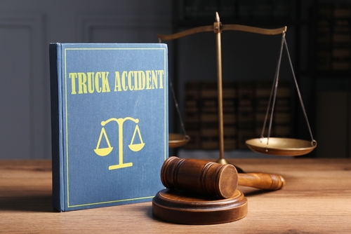 A truck accident book and a gavel to represent what a truck accident lawyer's job is.