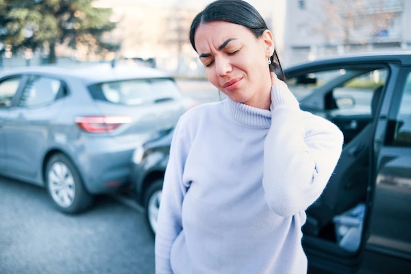 A woman suffers neck pain after a car accident.