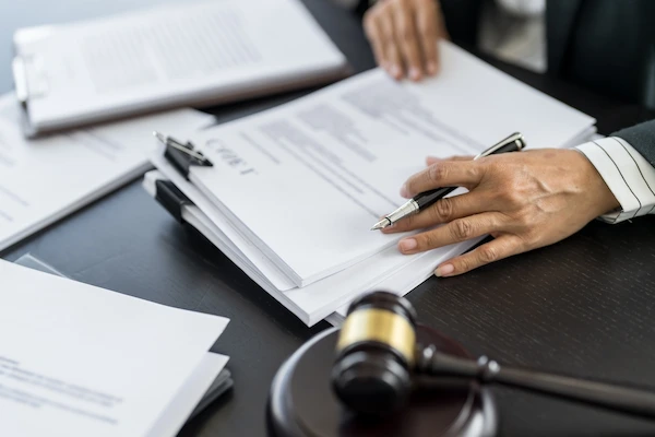 A Greenville bus accident lawyer at Car Crash Lawyers SC reviews legal documents.