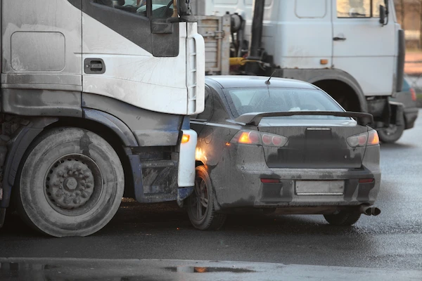 A car hit by a semi-truck represents a case handled by a truck accident lawyer.